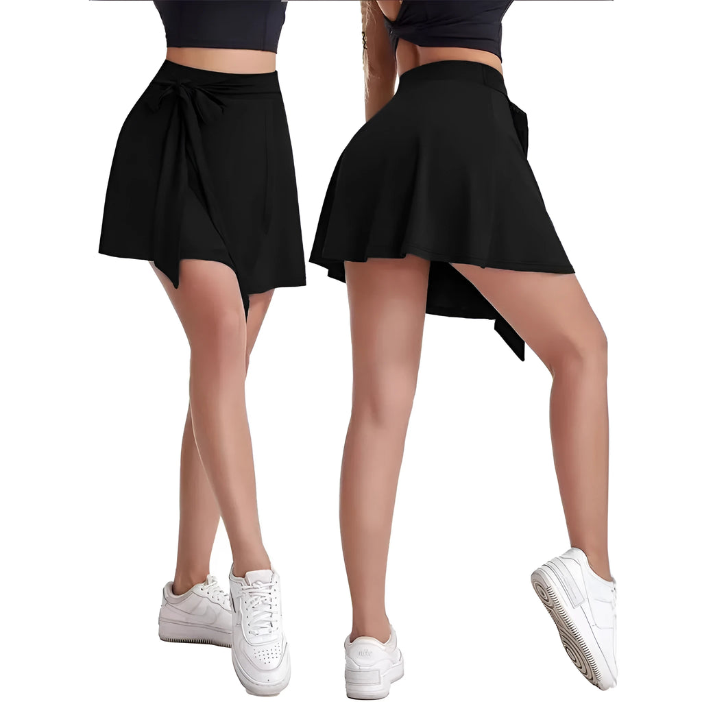 Black thigh-length sports skirt with high waist and built-in shorts, showing shoulder strap detail.