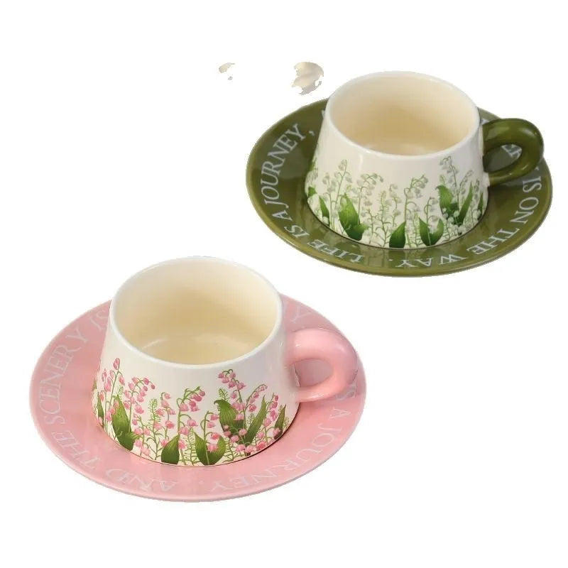 Ceramic coffee cup and saucer set with two cups, two saucers, and two spoons