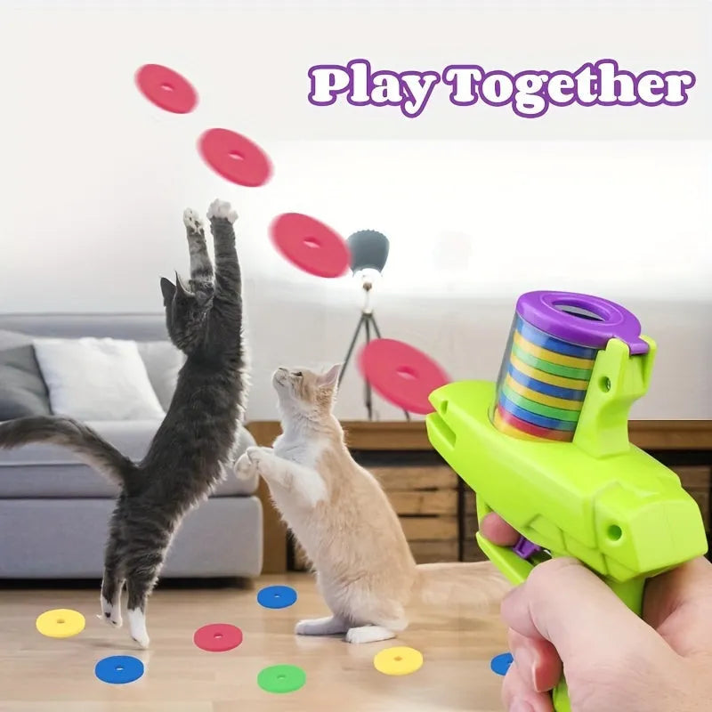 Green interactive cat toy launcher with foam disc on flat indoor surface.