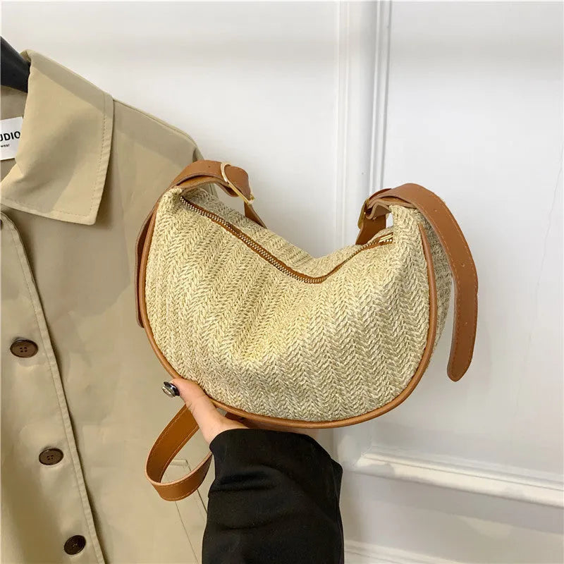 Women's woven straw crossbody bag showing internal phone pocket and file compartment in corrugated black colour