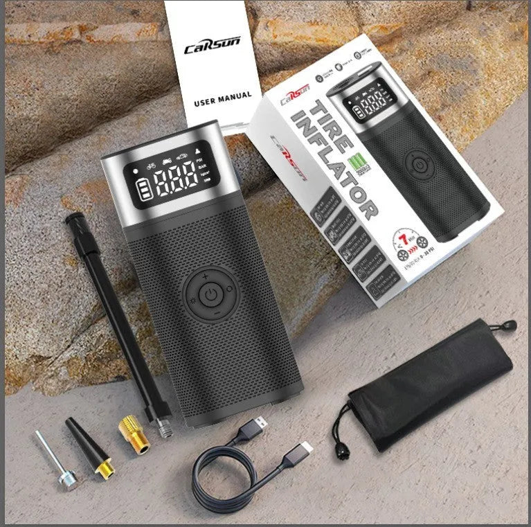 Black portable wireless smart vehicle air pump with USB cable and multiple inflation nozzles on a grey background.