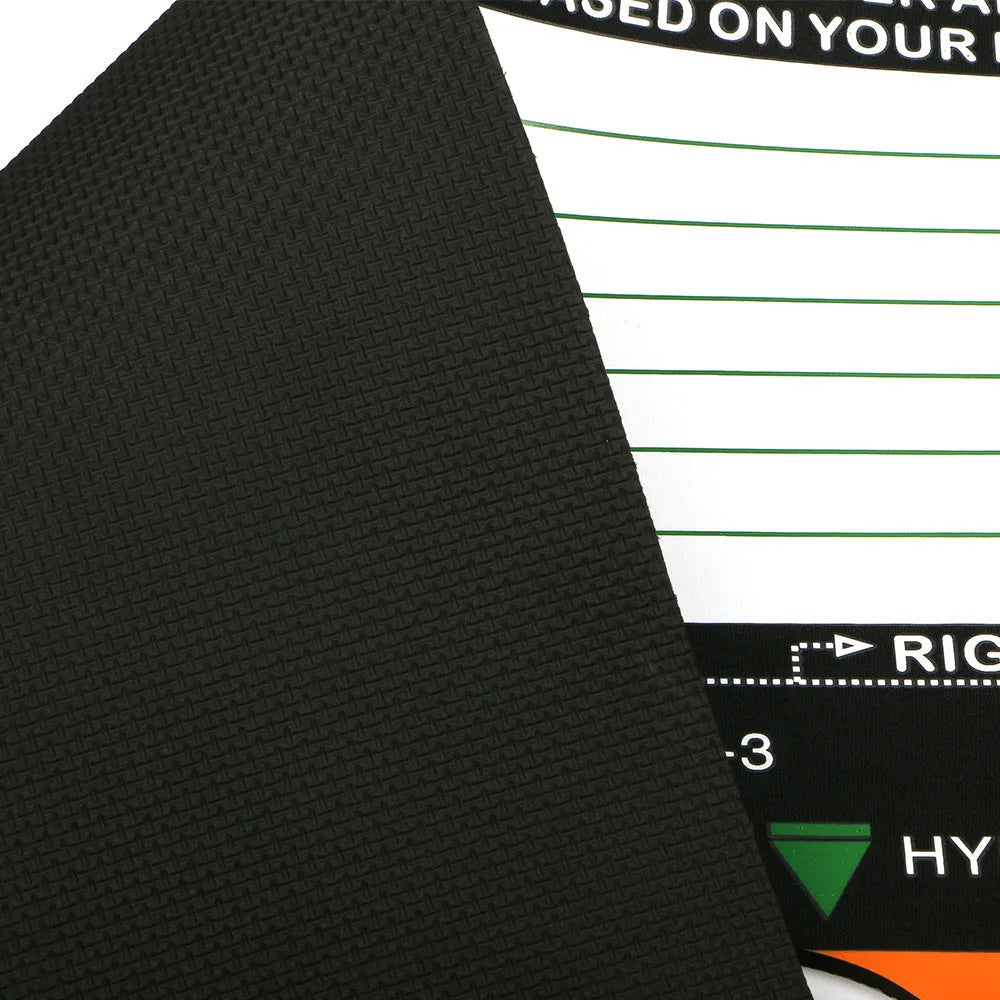 Black neoprene golf swing training pad for stance and posture correction on grass.