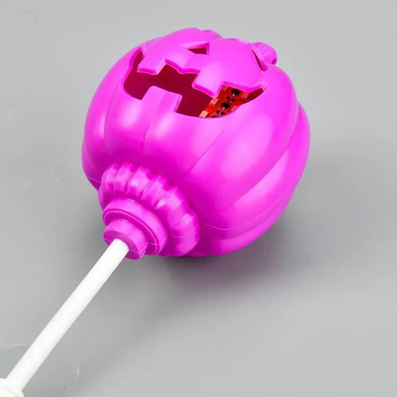 Plastic pumpkin-shaped decorative lamp with USB charging cable, showing purple or yellow light option.