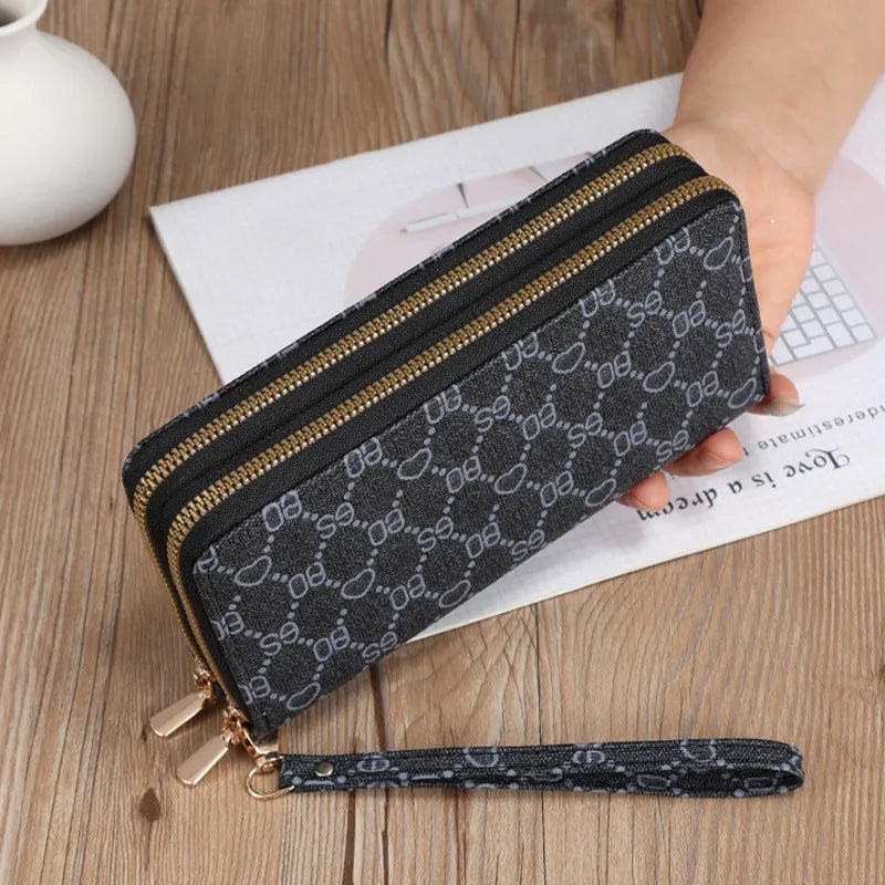 Long black PU leather wallet clutch with phone slot, card holders, and zippered coin purse
