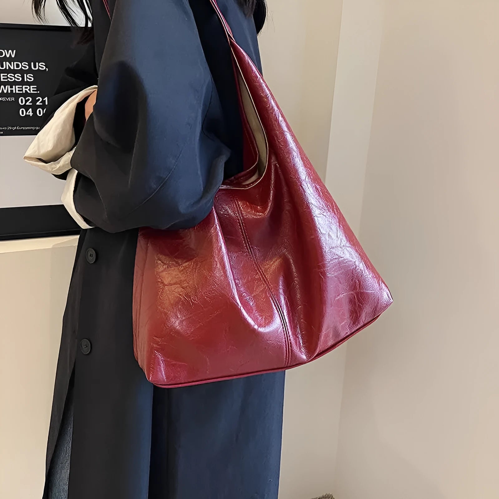 Casual soft PU leather shoulder bag in black with visible stitching and a front sandwich pocket.