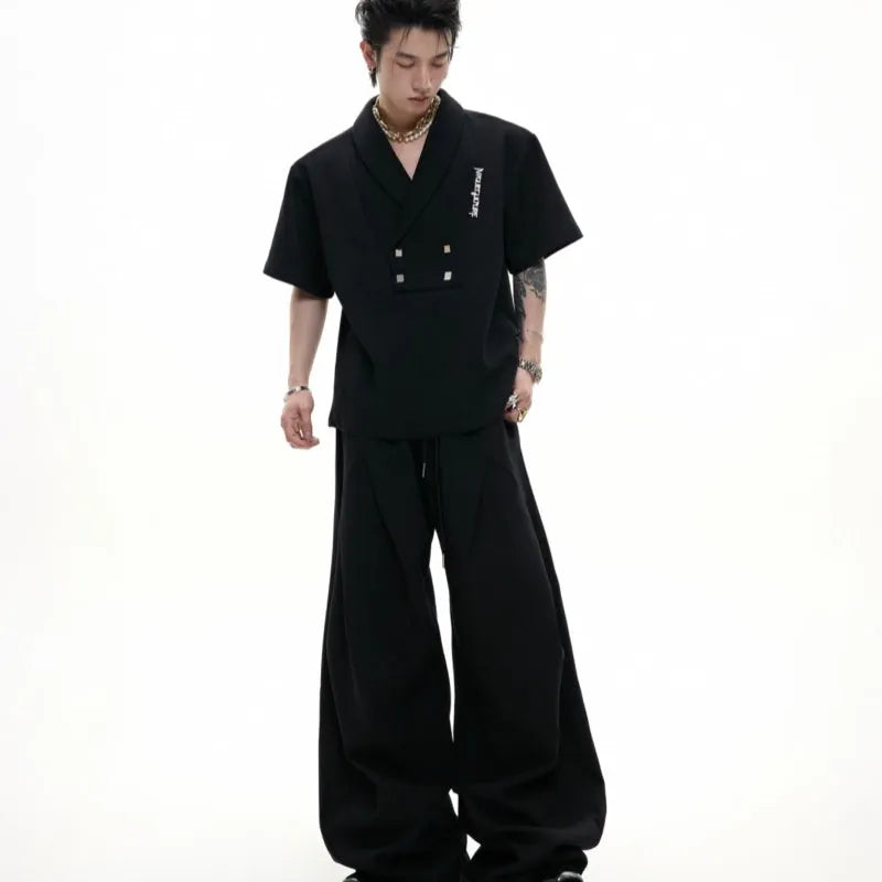 Man wearing a dark grey V-neck padded shoulder short sleeve jacket and matching shorts, a cotton sports suit set.