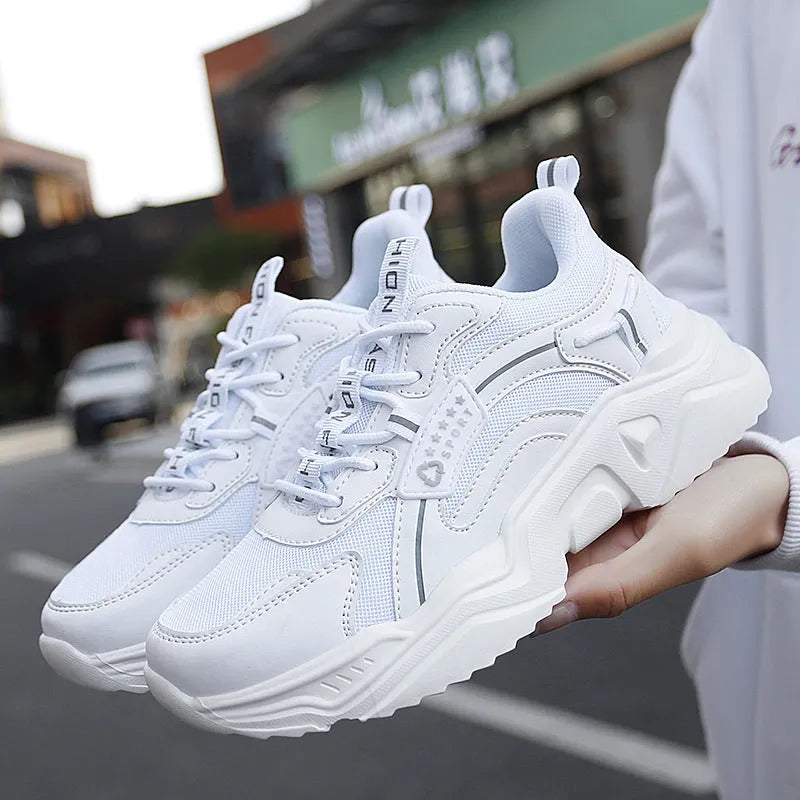 Women's white casual sports shoes with mesh upper, thick PU sole, and buckle detail