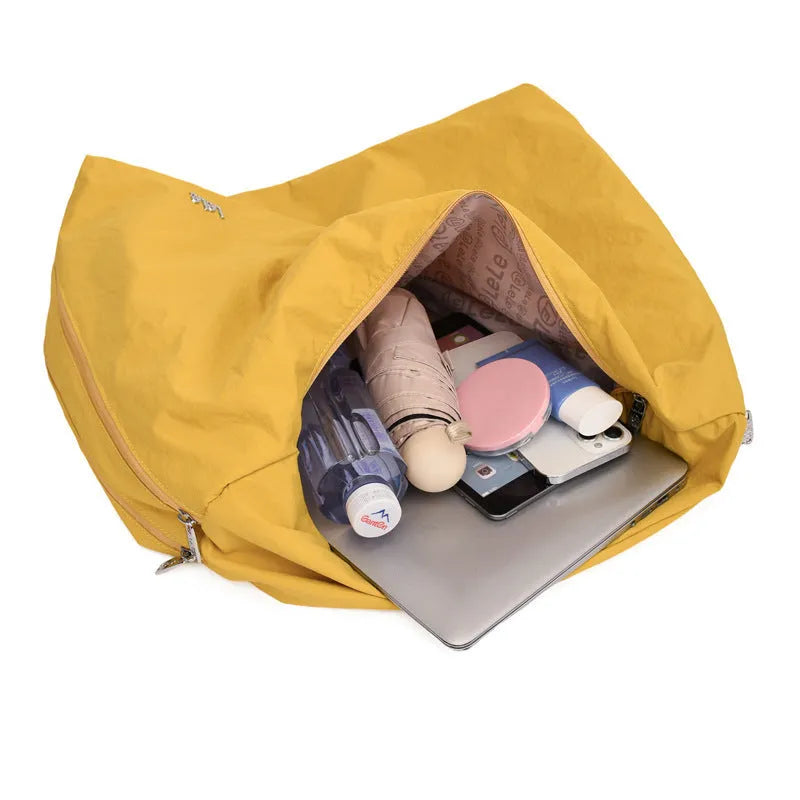 Soft nylon women's underarm bag in heart shape, shown in black, yellow, khaki, or blue.