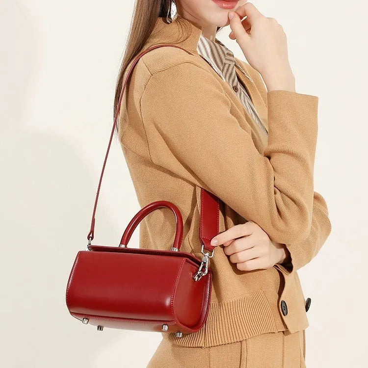 Brown genuine cowhide leather women's crossbody bag with clamshell opening shown open.