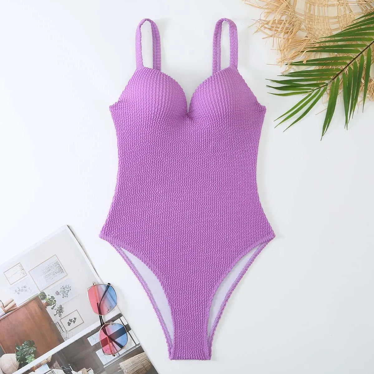 Women's black sleeveless one-piece swimsuit made from polyester fabric on a mannequin.