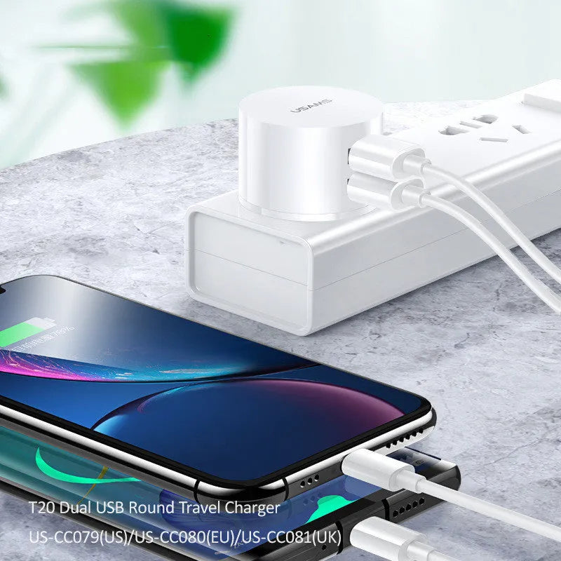 White universal USB phone charger with foldable US, UK, and EU plugs showing compact design