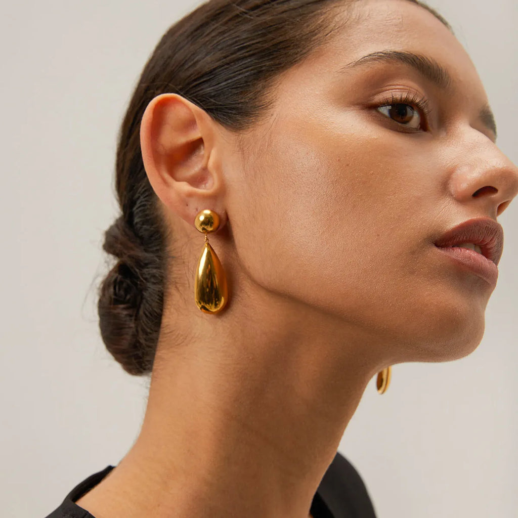 Gold electroplated stainless steel water droplet earrings with geometric hemisphere pendant design