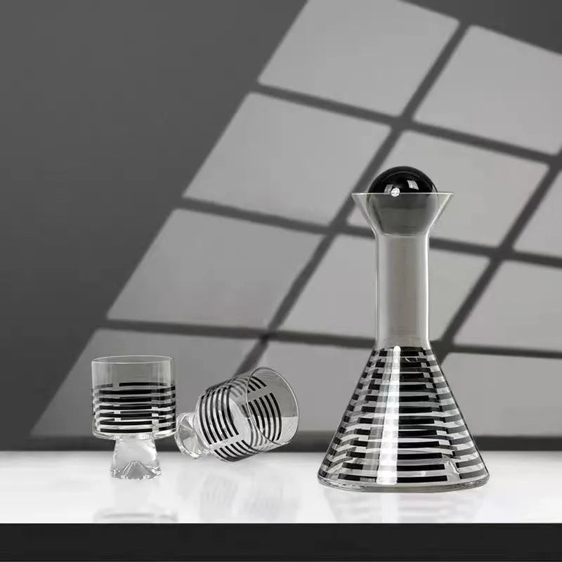 Modern black striped glass cold water bottle 1000ml with two cups on a light surface