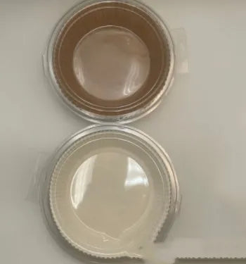 Round white disposable parchment paper liner for air fryer basket with raised edges.
