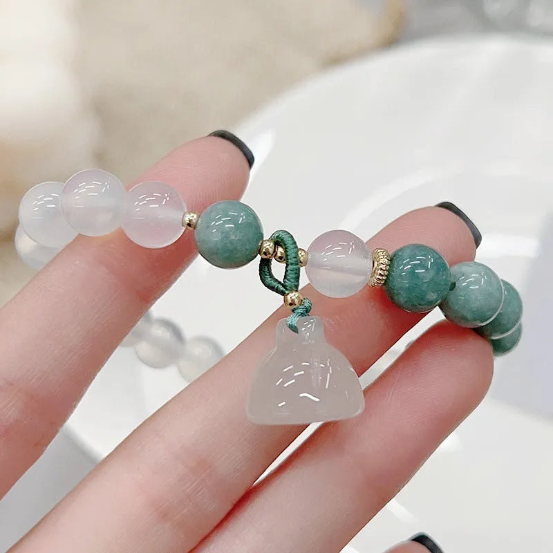 Women's retro Chinese style agate lotus seedpod bracelet with Burma jade accents on wrist