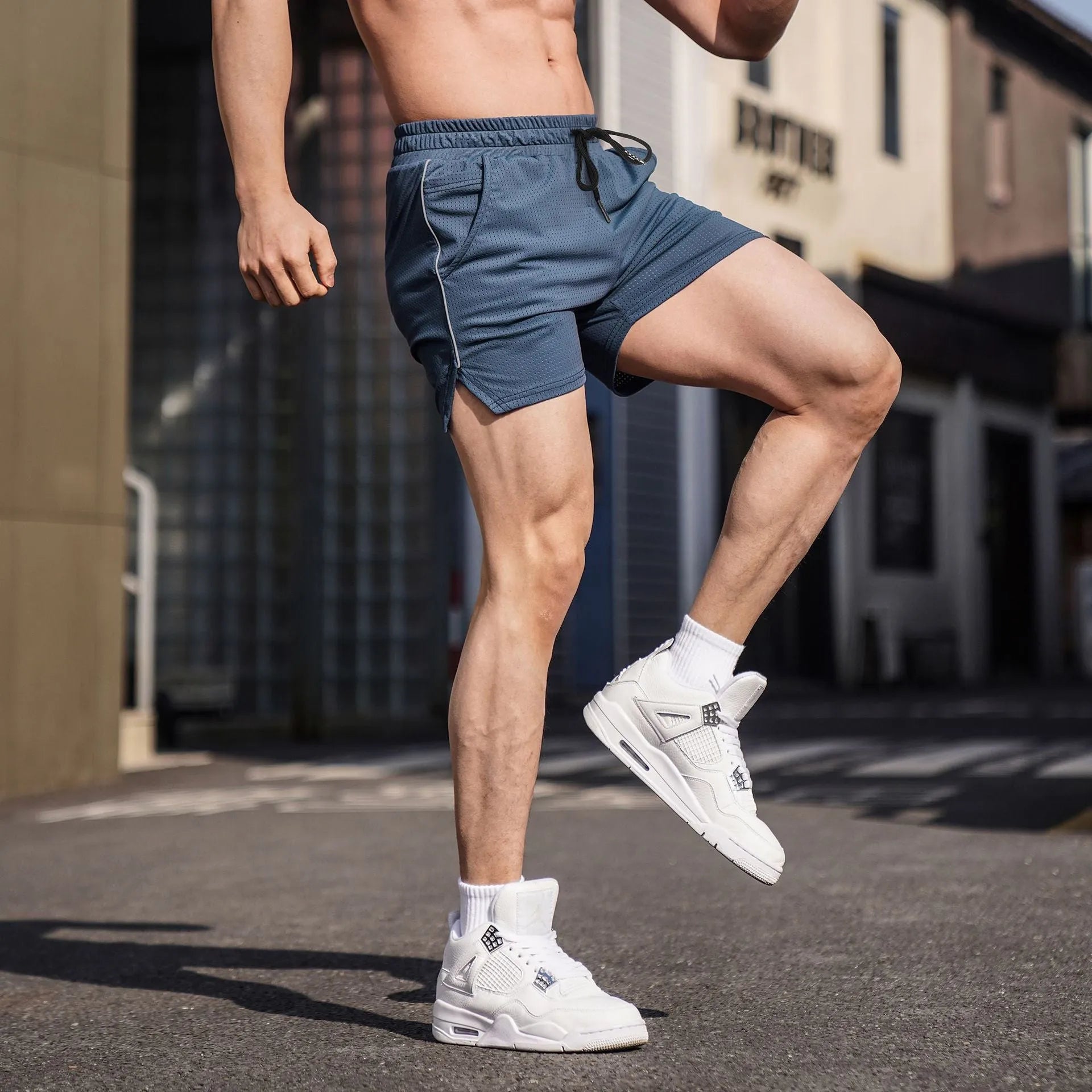 Men's straight-leg polyester sports shorts shown in black, grey, navy, and red colours