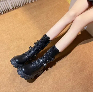 A pair of women's black mid-calf knight boots with a side zip and a large metal buckle strap.