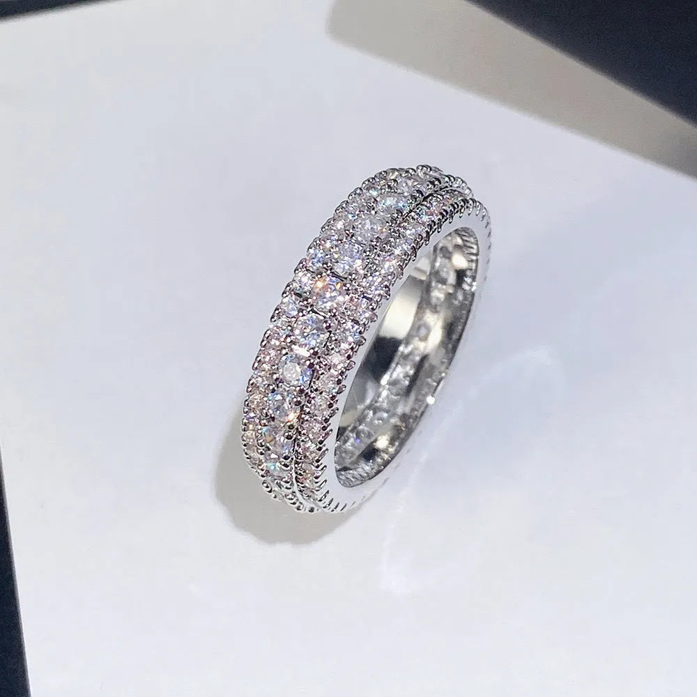 Geometric triangular personalised engagement ring with zircon stones in gold and platinum colour finishes.