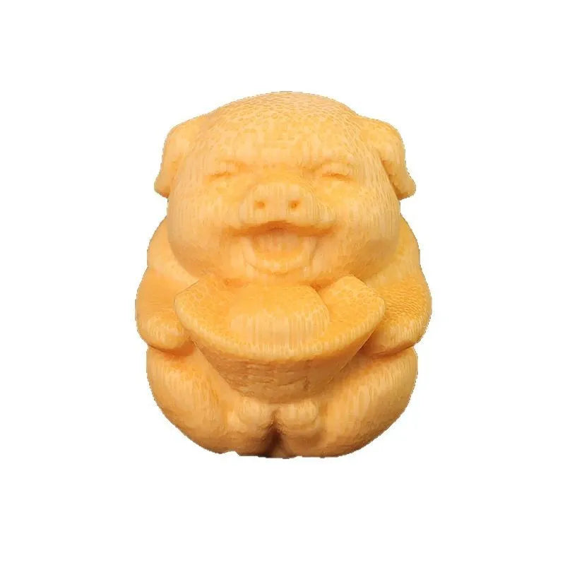 Small cute Fulu Pig bamboo carving ornament on a surface, showing its ingot shape.