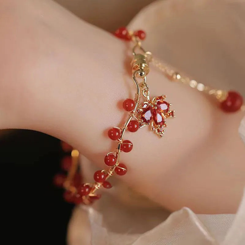 Red ginkgo leaf charm on a silver-toned magnetic alloy bracelet in Chinese natural style.