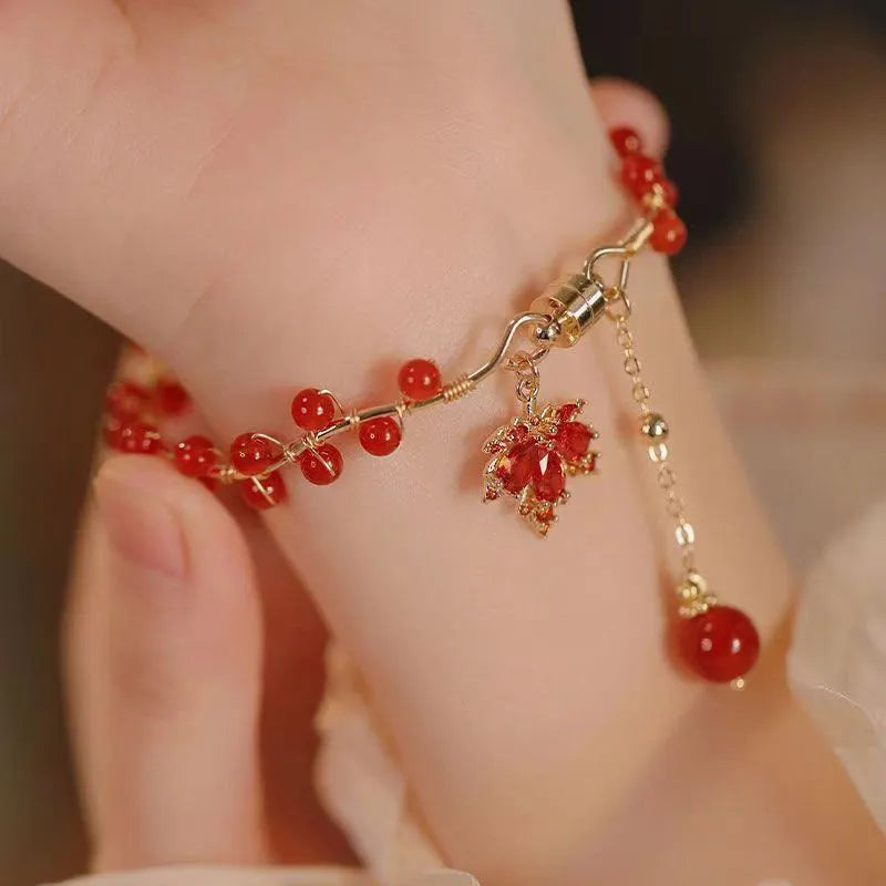 Red ginkgo leaf charm on a silver-toned magnetic alloy bracelet in Chinese natural style.