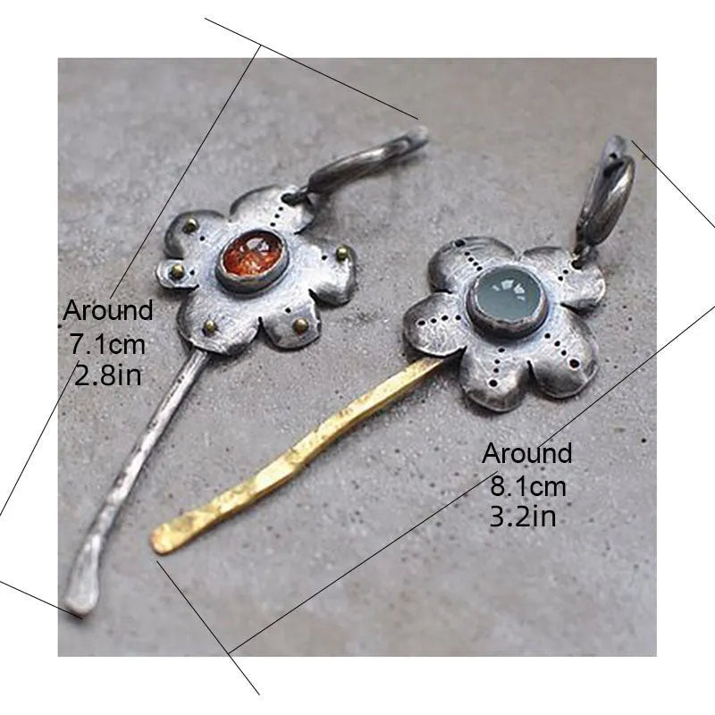 Long retro earrings with two-tone floral geometric design in alloy with electroplated finish.