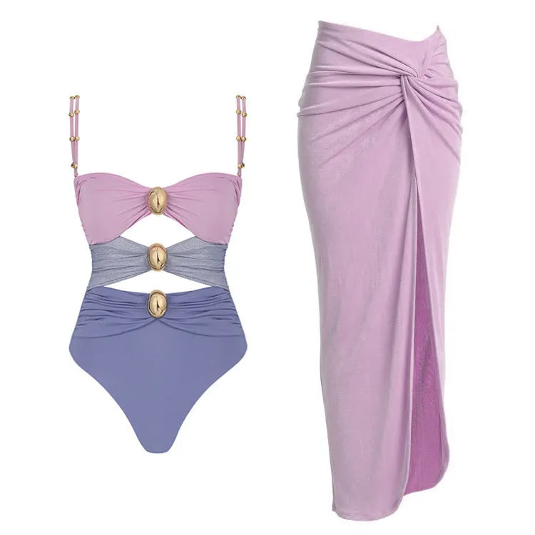 Women's solid colour one-piece swimsuit with an attached short skirt and gold button decoration.