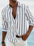 Man wearing a loose fit yarn-dyed striped long-sleeved casual shirt in British cardigan style.