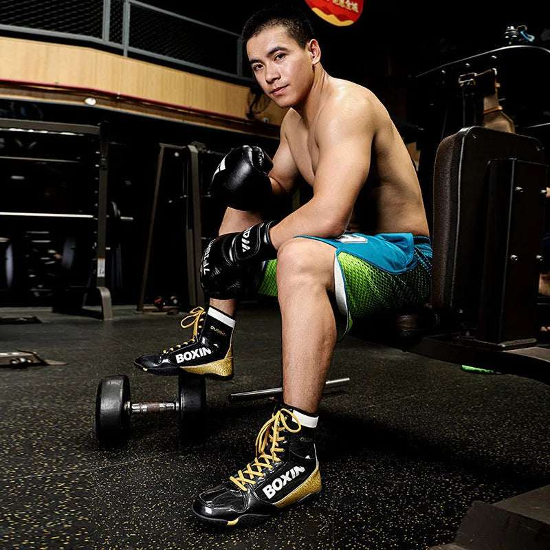 Unisex high-top mixed combat training shoes with mesh and leather upper in black gold colour.