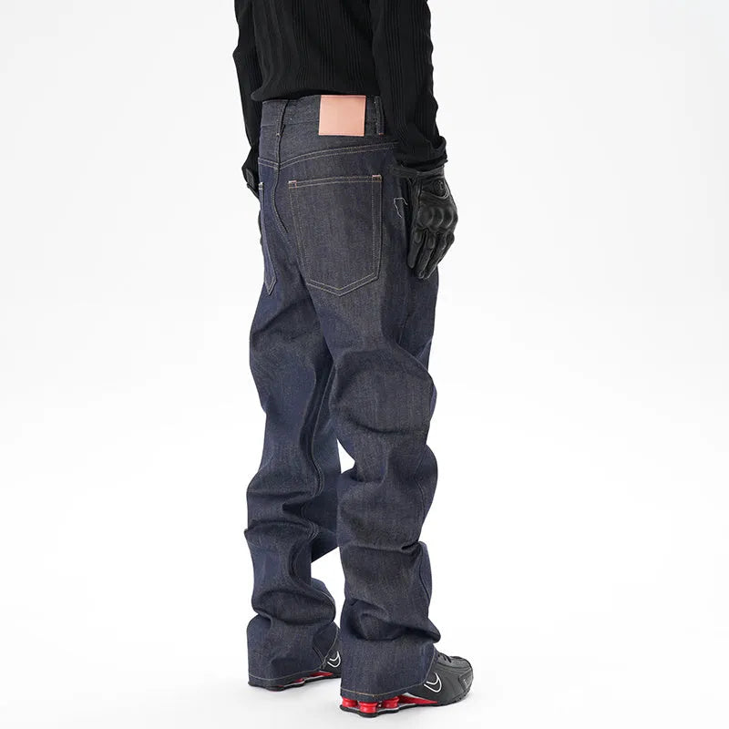 Man wearing dark blue loose straight-leg casual jeans.
