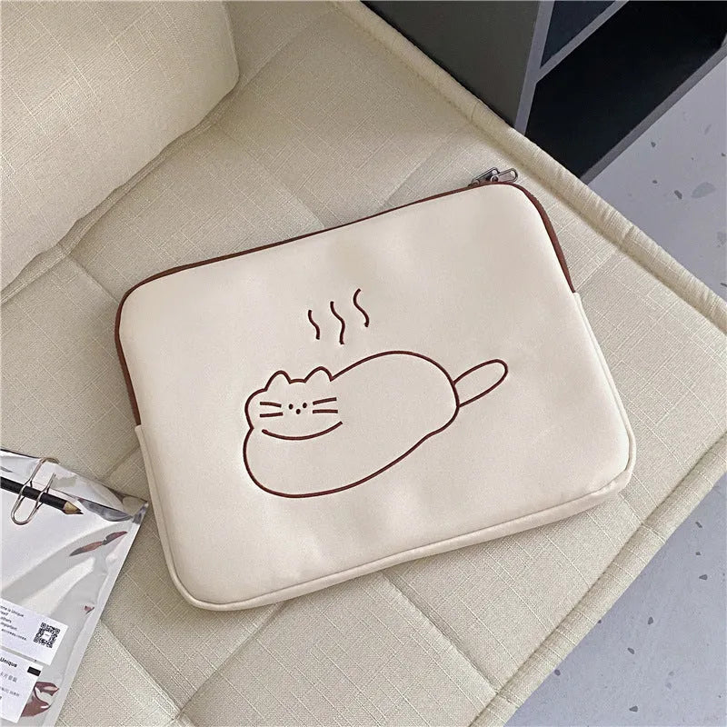 Embroidered fat cat design on a grey nylon laptop protective sleeve with a black zipper.