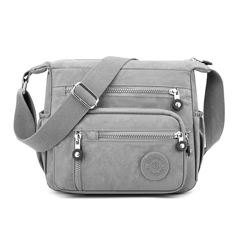 Grey nylon messenger bag with single shoulder strap showing square vertical shape