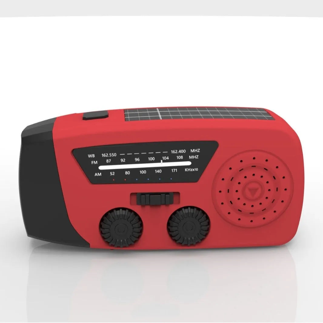 Red rechargeable emergency hand-crank radio with LED torch and USB port for disaster prevention