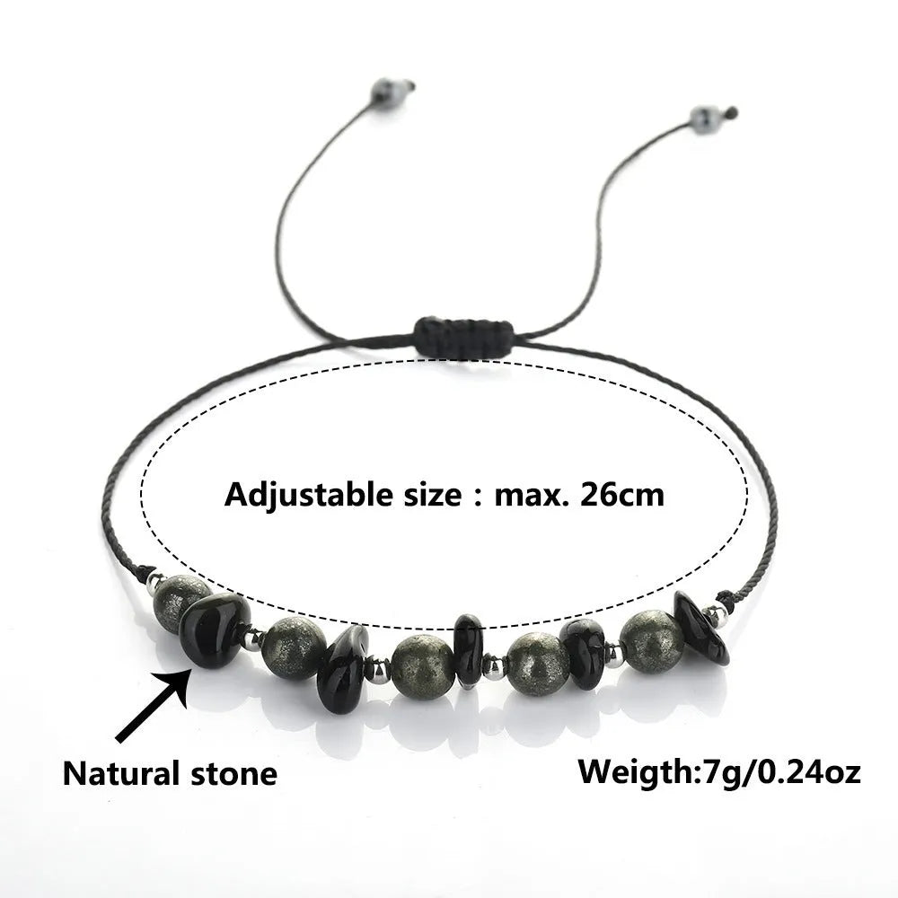 Close-up of a black garnet stone beaded bracelet with geometric design and moon charm.