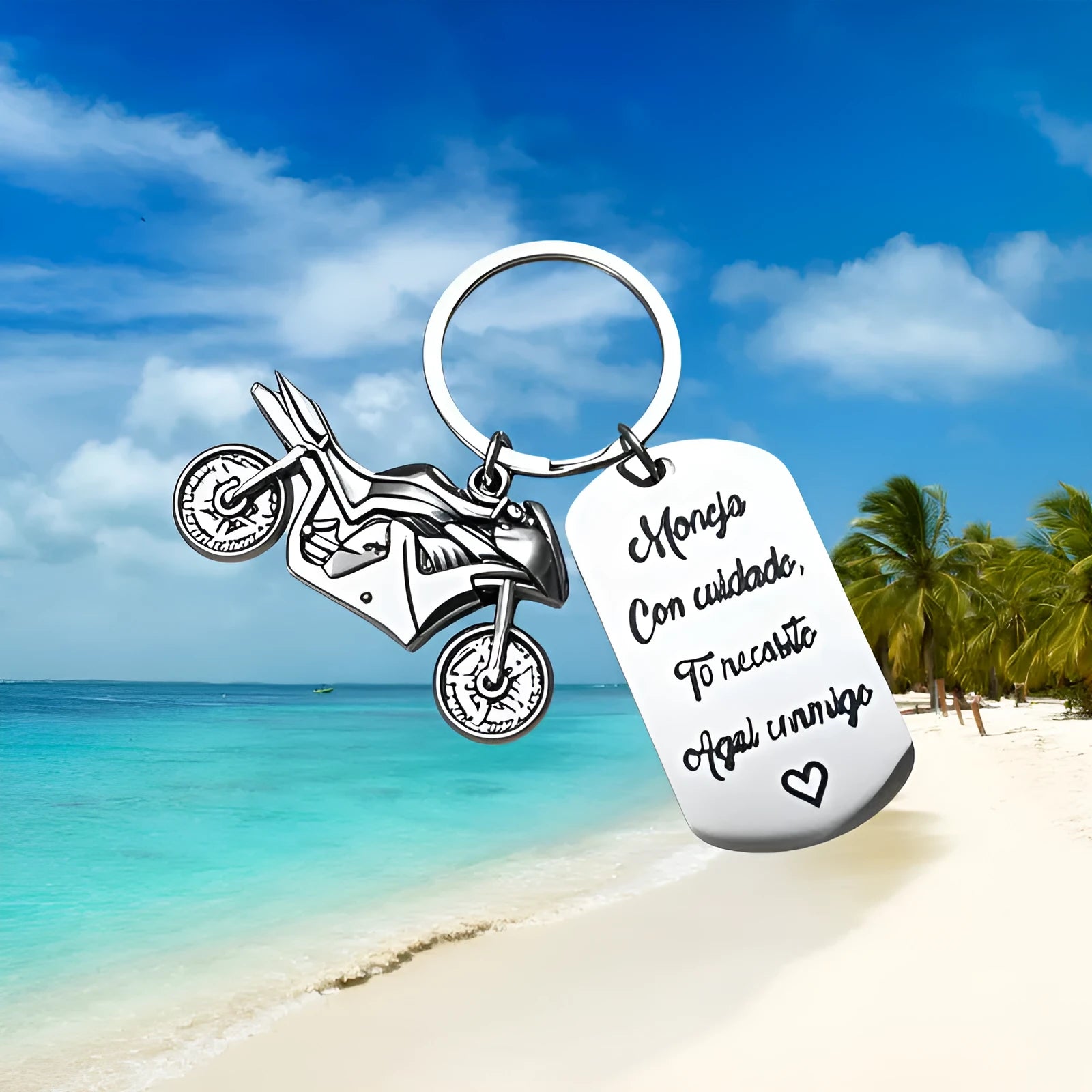 Stainless steel motorcycle keychain with inspirational design, shown with its included flannel storage bag.