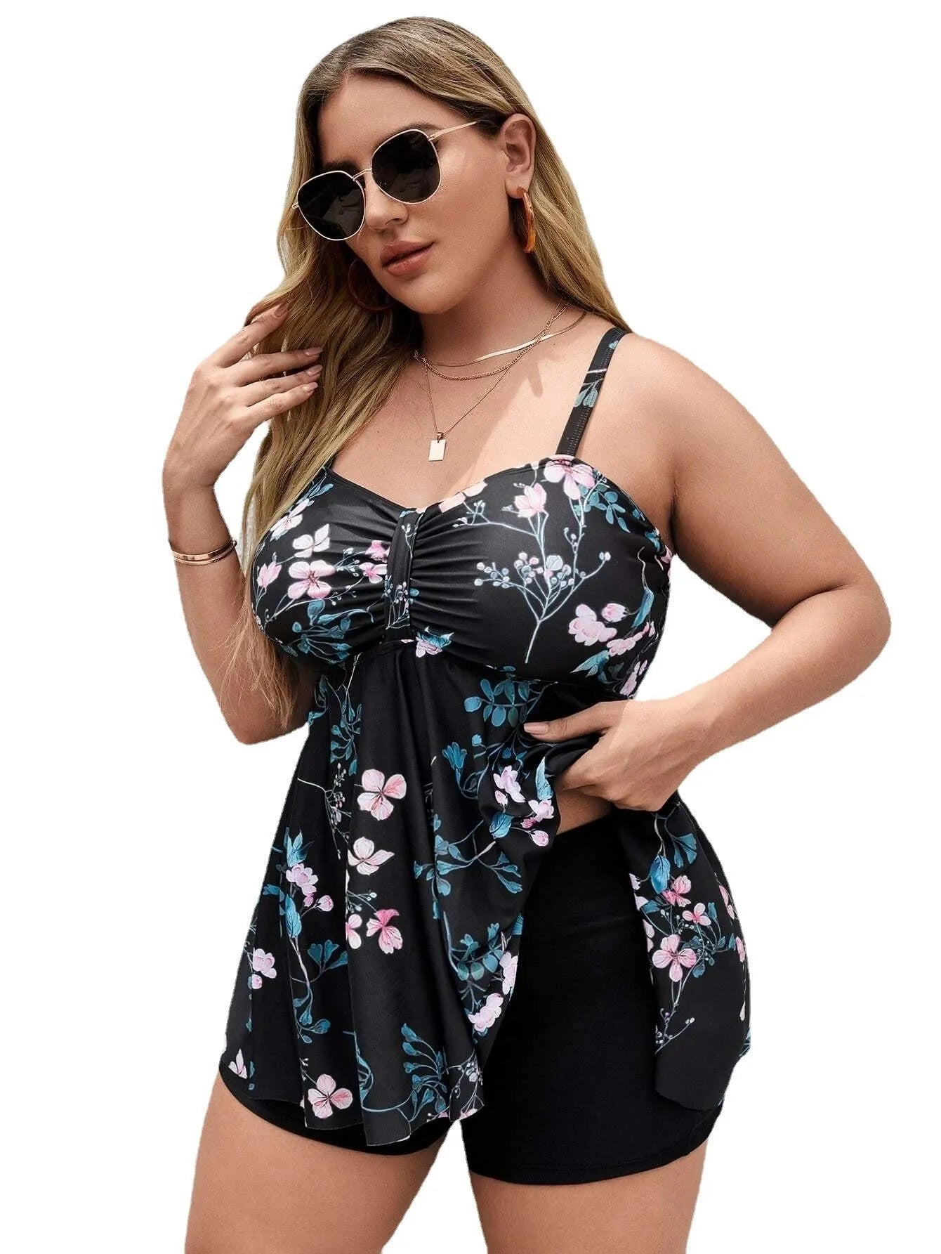 Women's floral print one-piece swimsuit with split colour design, shown on a hanger.