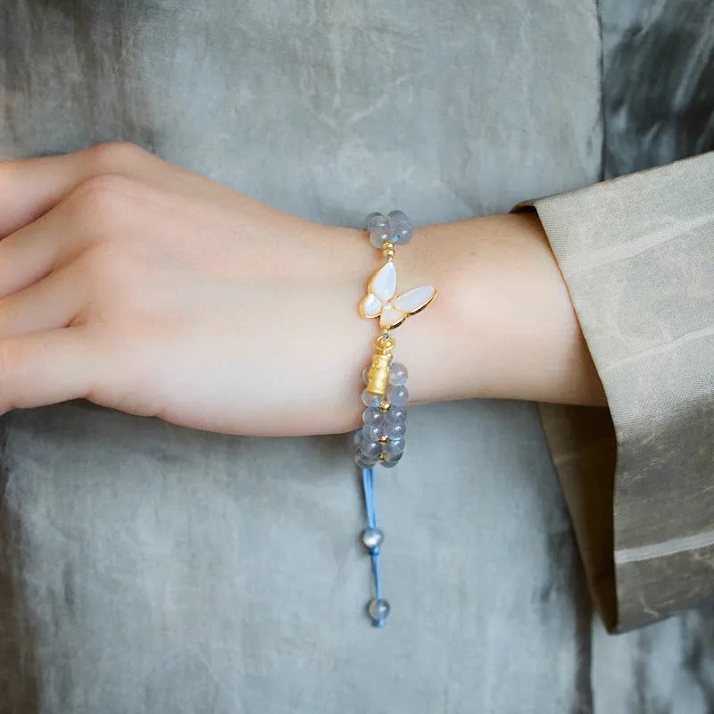 Handmade geometric woven bracelet for women with a grey moonstone and butterfly design.