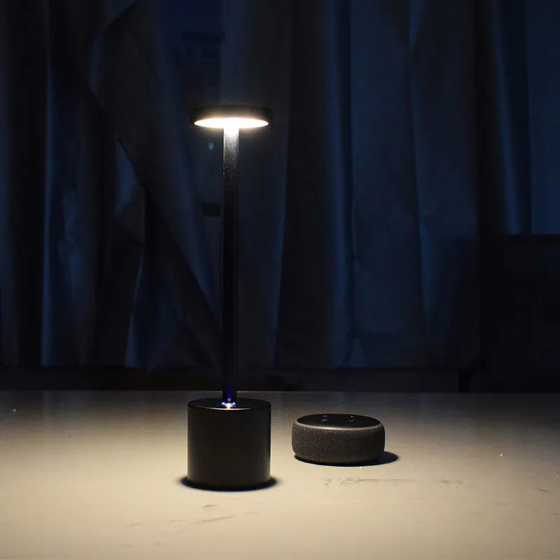 All-aluminium rechargeable LED touch desk lamp in black finish on a wooden desk