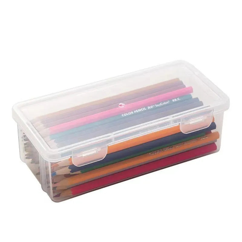 Transparent plastic stationery storage box containing colour pencils and drawing supplies