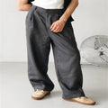 Men's loose fit pleated high waist jogger pants in a light grey colour, showing the casual straight-leg style.