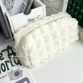 Cream puff style fabric pencil case in beige or black colour made from polyester material