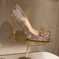 Women's gold stiletto heels with rhinestone decoration and pointed toe