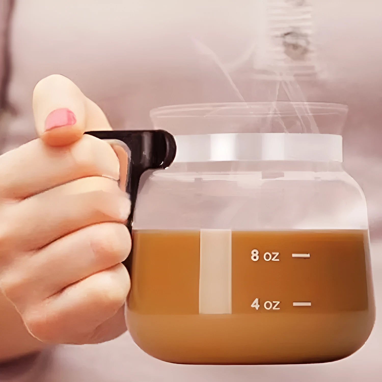 Transparent borosilicate glass coffee maker with removable silicone cover showing modern simple design