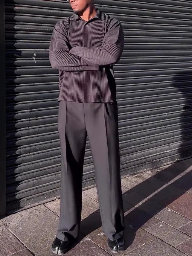 Men's black pleated long-sleeved casual top made from polyester, shown on a model.