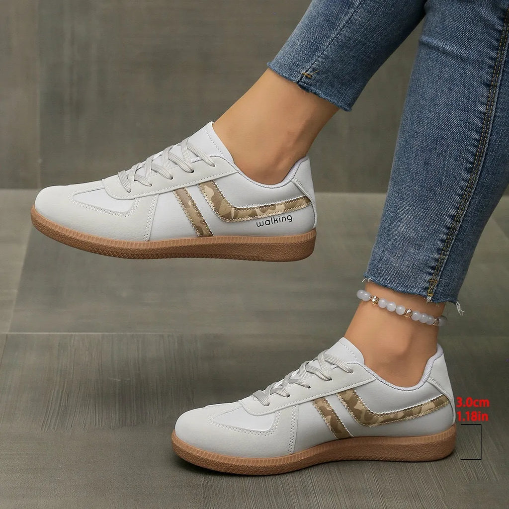 Women's retro casual sneaker in a wine red colour with a round toe, flat rubber sole, and front lace-up fastening.