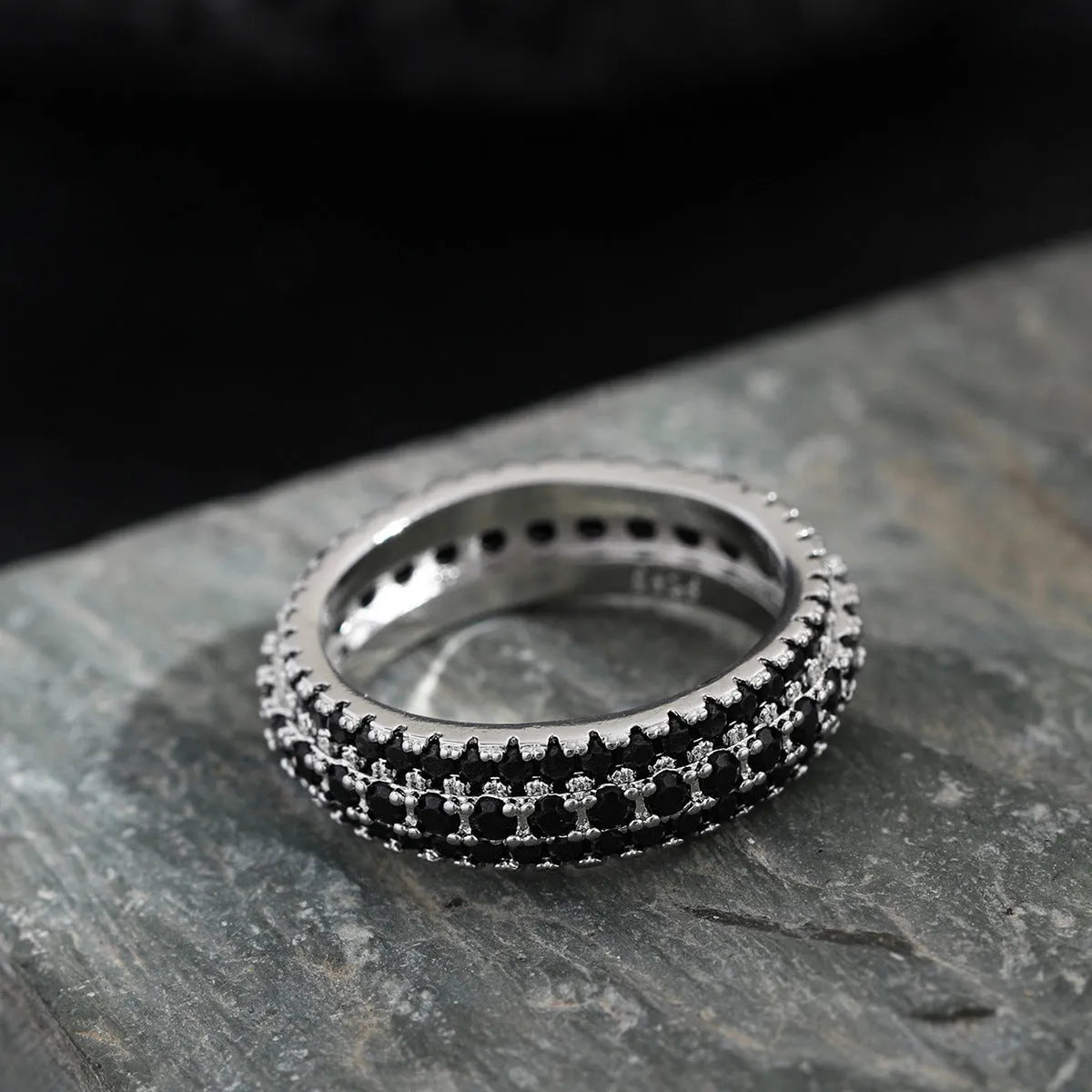 Geometric triangular personalised engagement ring with zircon stones in gold and platinum colour finishes.