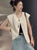 Women's short length polyester vest in milky white with front pockets