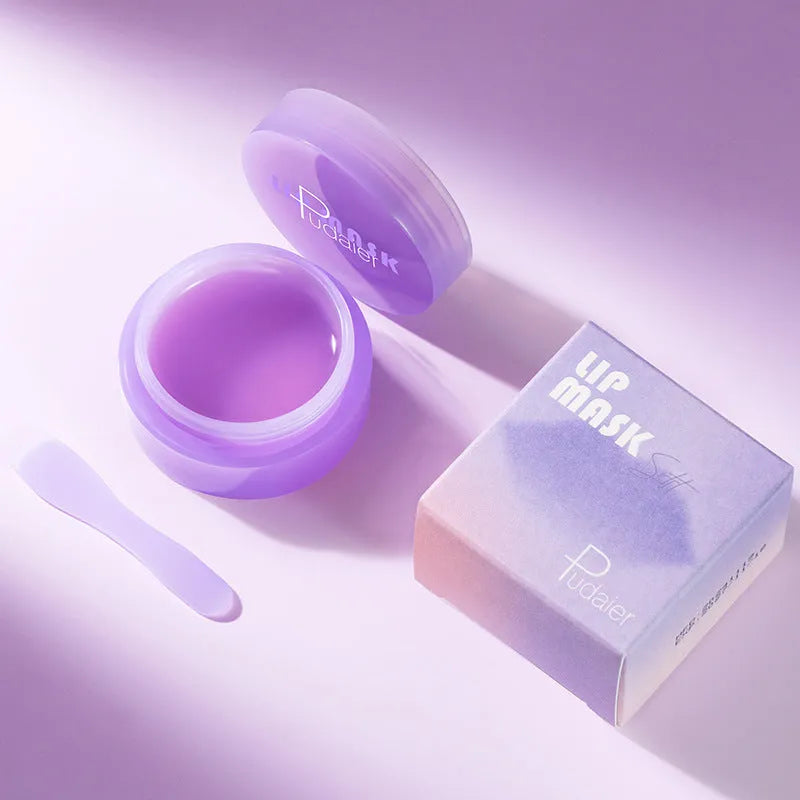 Exfoliating lip balm jar with lid alongside lip mask and scraper tool on white background