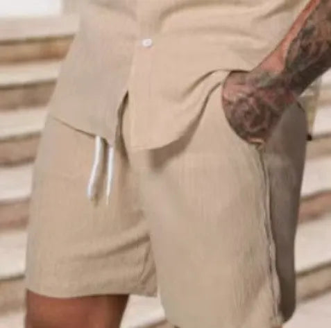 A striped printed casual suit for men, showing the short sleeve shirt and matching shorts on a hanger.