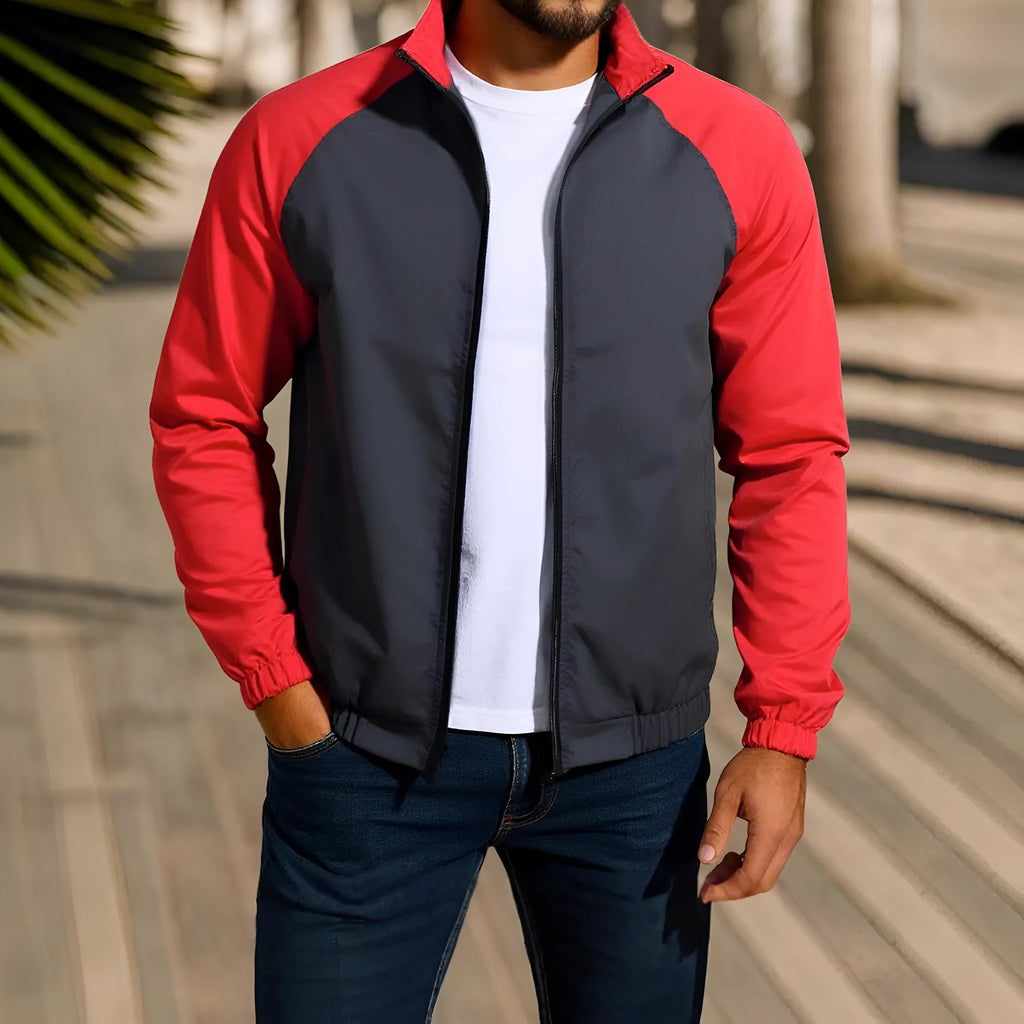 Man wearing a green stand collar casual jacket with raglan sleeves.